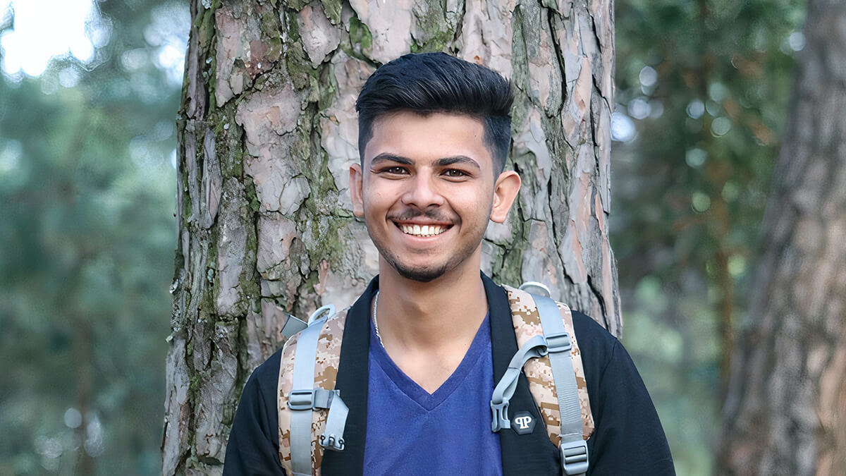 smiling young man on a hike